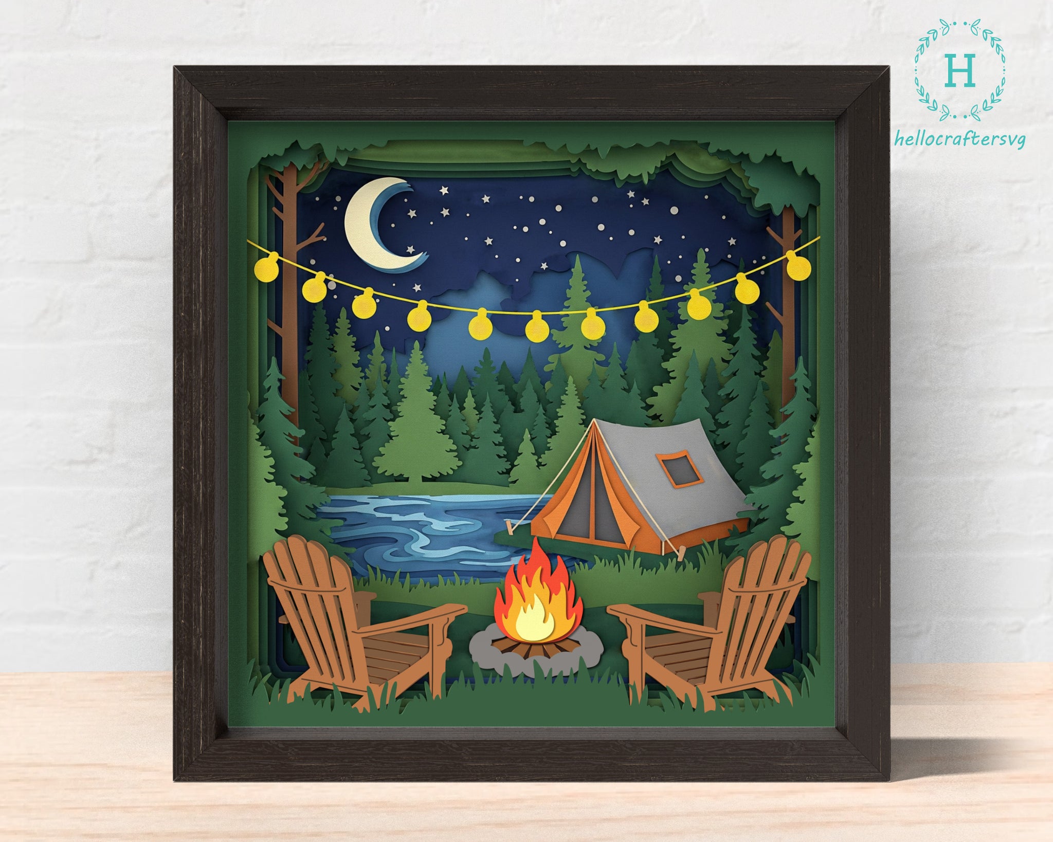 Framed artwork of a camping scene with a tent, fire pit, and chairs under a starry night sky. 3D camping tent Shadow box Svg 